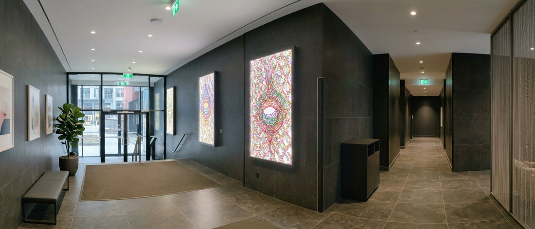 Acrylic light panels with illuminated wall art in a modern hallway